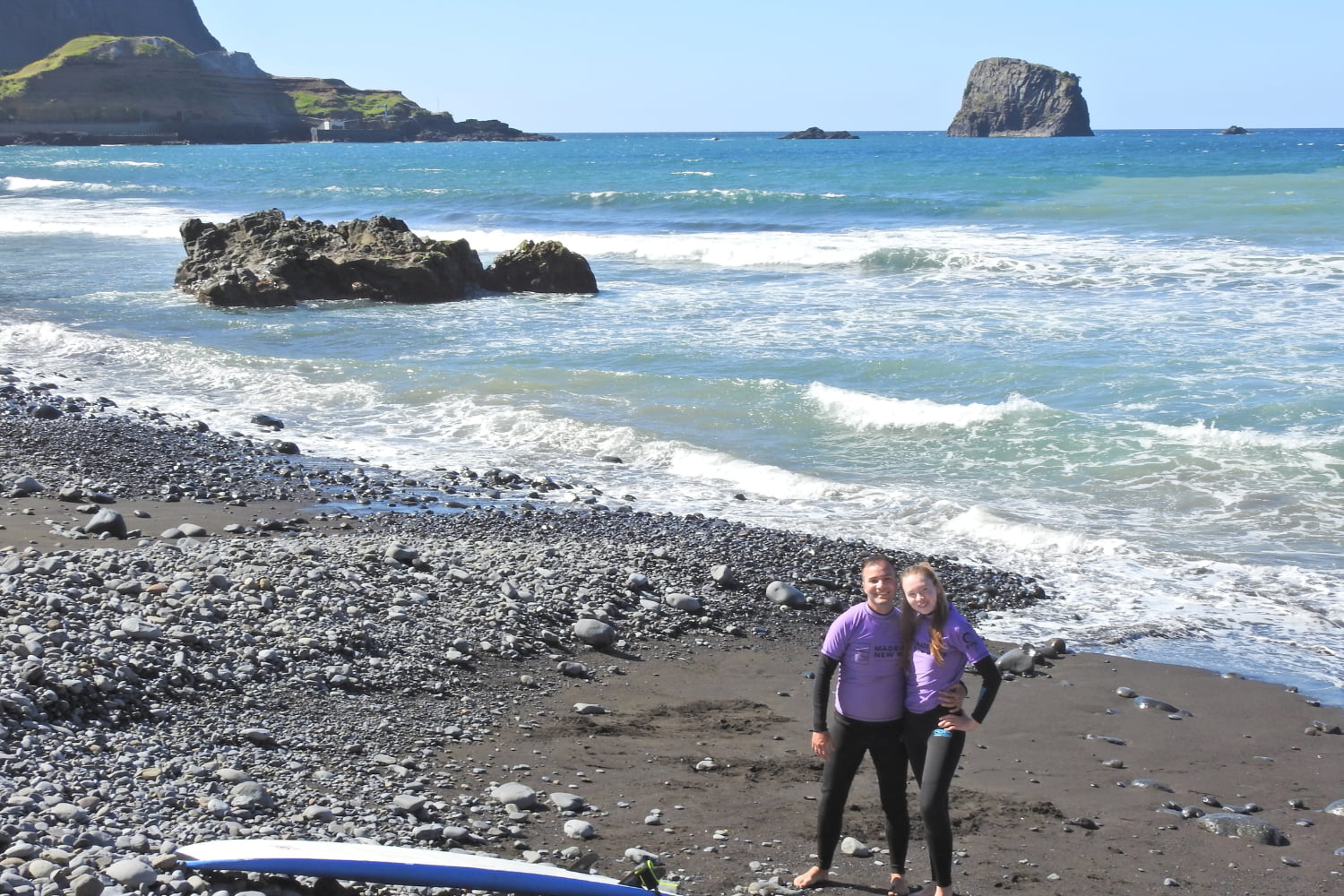 A couple of bodyboarders in a volcanic beach from Porto da Cruz ready to start their group bodyboard lesson in madeira