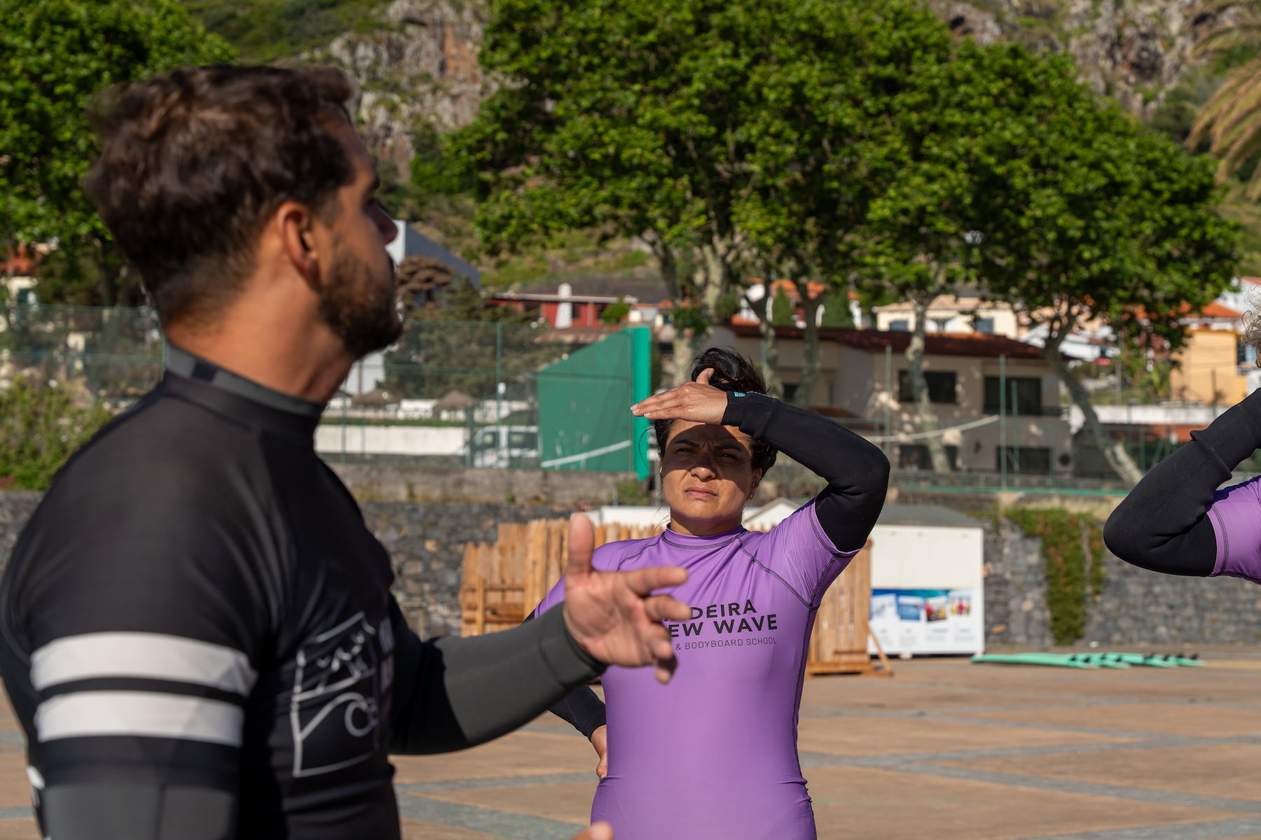 Surf instructor giving tips to the surfers before their surf lesson