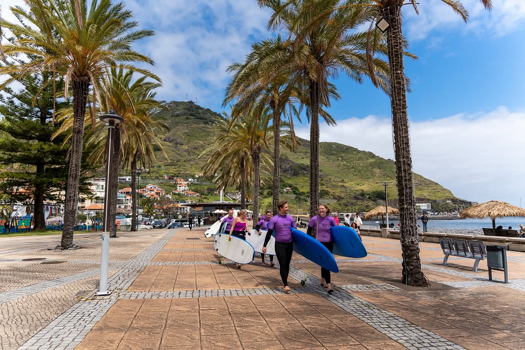 Group of surfers happy with their rented surfboard in madeira