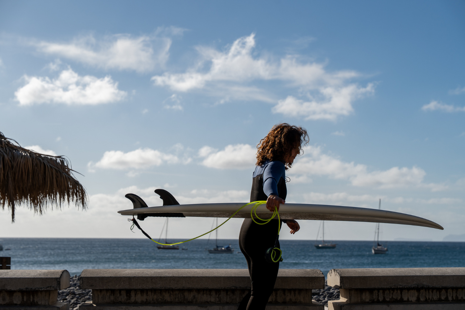 Experienced female surfer with a rented surfboard in Madeira prepared to follow the advice from her surf guide