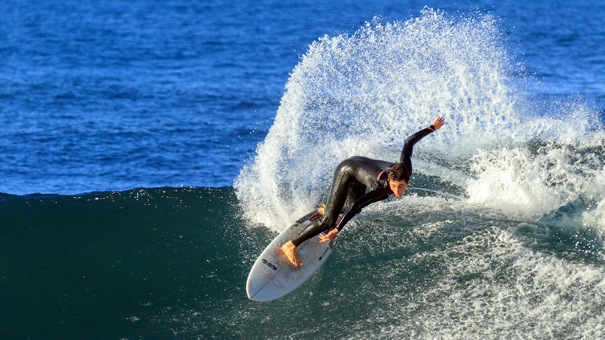 Surfer riding waves in Madeira
